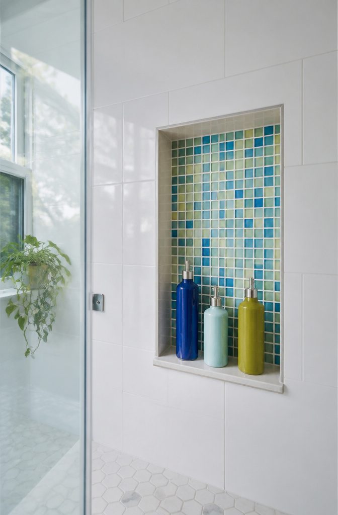 10 Cute Bathroom Ideas for Colorful, Playful Spaces (2026) 4 Shower niche with colorful mosaic tiles in blue, green, and yellow.